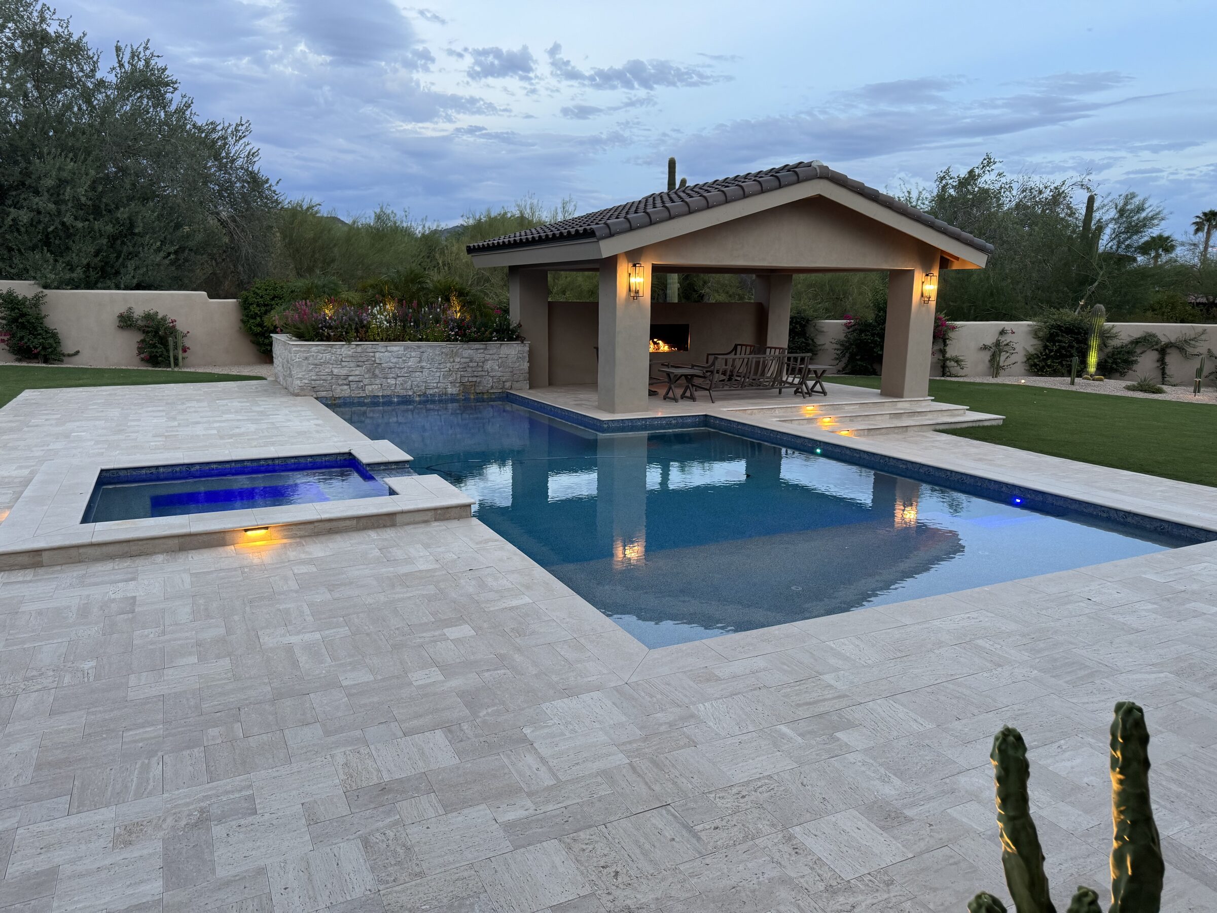 Luxury Scottsdale backyard with custom pool, spa, travertine decking, and ramada